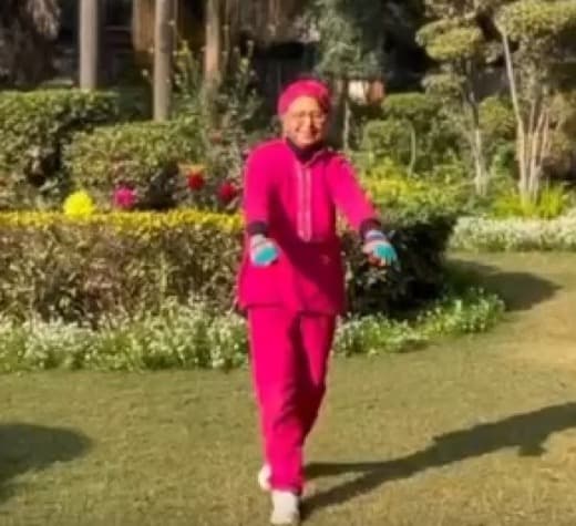 A senior MoveU client exercising in a garden
